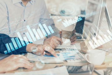 Multi exposure of chart with man typing on computer in office on background. Concept of hard work.