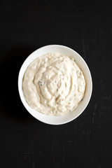 Homemade Caramelized Onion Dip on a black surface, top view. Flat lay, overhead, from above. Close-up.