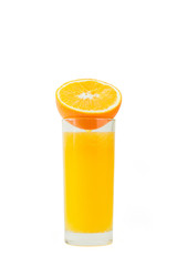 A cup of orange juice and cut orange on  white background.