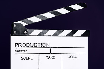 movie clapper on purple violet background