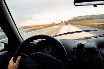 Driving a car on a summer sunny day.