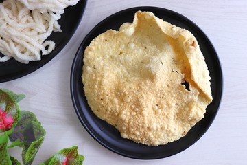 Indian crunchy fried snack papad or Papadam made of rice floor served in a plate. Also known as khichiya Papad.