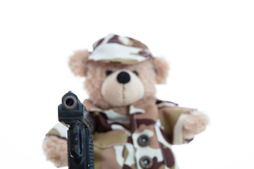 Cute teddy bear in soldier uniform with a handgun isolated against white background