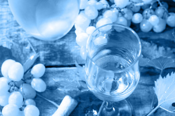 Classic blue 2020. Gradient color palette. Wine background. Wine in glasses, bottle, grapes on vintage background, wine concept.