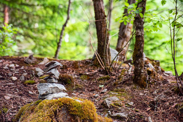 Pyramid of balancing stones in forest, soft focus