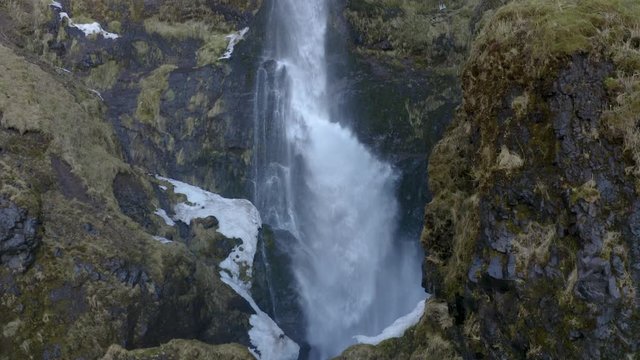 Flying straight up in slow motion close to a waterfall in south Iceland.