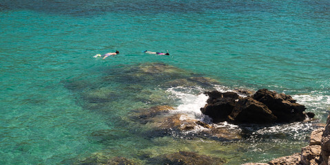 Above view of a snorkeling couple in the sea