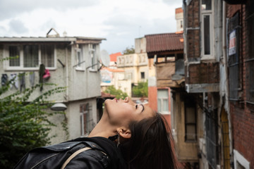 Asian girl looking up in profile in old Istanbul's district Fener/Balat