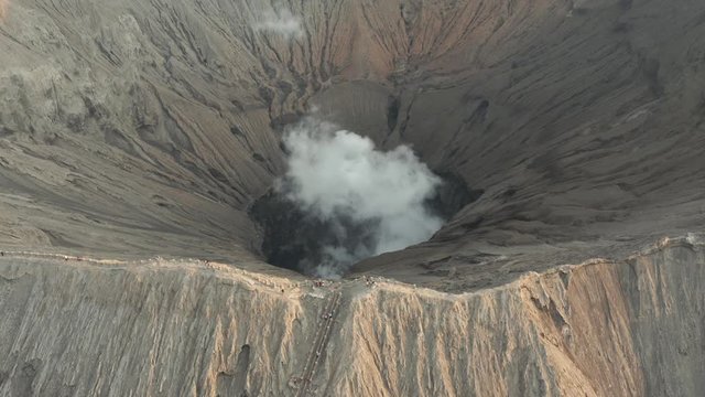 Aerial drone view of volcanic gas and steam venting from the active crater of a volcano (Mount Bromo, Java, Indonesia)