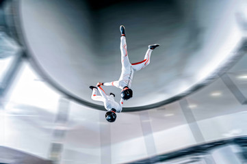 Speed. Fly men is a pilot of his body in air. Extreme people prefer skydiving. Parachutist in white suit. Free lifestyle.