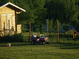children's electric car in the garden in summer, Russia.