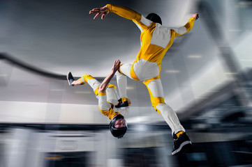 Speed. Fly men is a pilot of his body in air. Extreme people prefer skydiving. Parachutist in yellow suit. Free lifestyle.