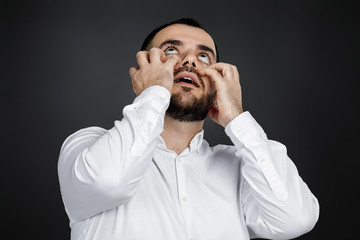 bearded man keeps hand on head on black background. man forget about something. Oh, my God