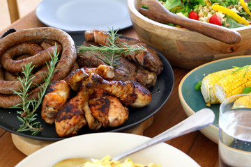 colourful barbeque braai plated meal consisting of chicken, steak, boerewors salad and coleslaw laid out and ready to eat on table