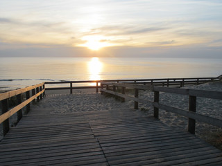 Naklejka na ściany i meble Sunset on Lacanau beach wooden path medoc ocean france
