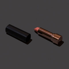 Diagonal laying light nude lipstick in luxury black fake skin packaging.