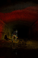 Man with gas mask in tunnel. light painting