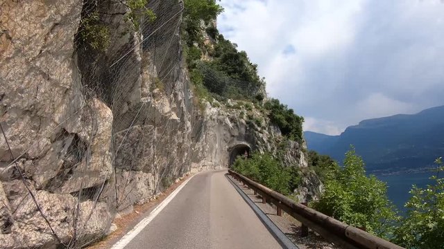 Garda lake, Italy. Driving along the Strada della Forra, one of the most scenic and famous drives in the world. Winston Churchill defined it as the eighth wonder of the world. Driver point of view