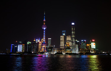 Fototapeta premium Panoramic picture of skyscrapers of Pudong district from the Bund in Shanghai at night in winter