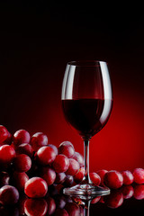 Glass of a red wine with grapes