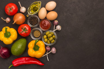 A set of vegetables for a healthy diet, yellow and red peppers, tomatoes, onions, garlic, eggs, olives, rocket,  spinach.  .