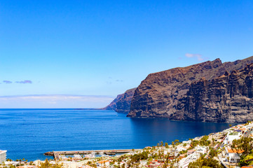 Magnificent views of The Gigants cliffs and the Port of Santiago from the Achipenque Lookout. April 13, 2019. Santiago Port, Santa Cruz De Tenerife Spain Africa. Travel Tourism Street Photography.
