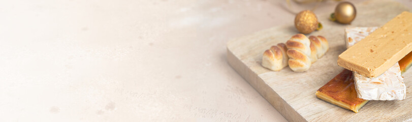 Traditional Spanish Christmas sweets turron, almond nougat and marzipan on large wooden background...