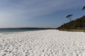 Hyams Beach - The whitest sandy beach in the world with a beautiful sunrise, with surrounding mountains and many trees.