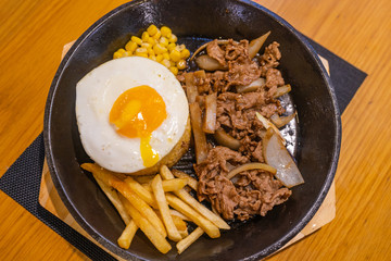 Top view photo of delicious stir-fried meal on sizzling platter 