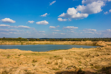 Fototapeta na wymiar View of the sand and gravel pit, part of the quarry is flooded with water. Maloyaroslavets, Russia