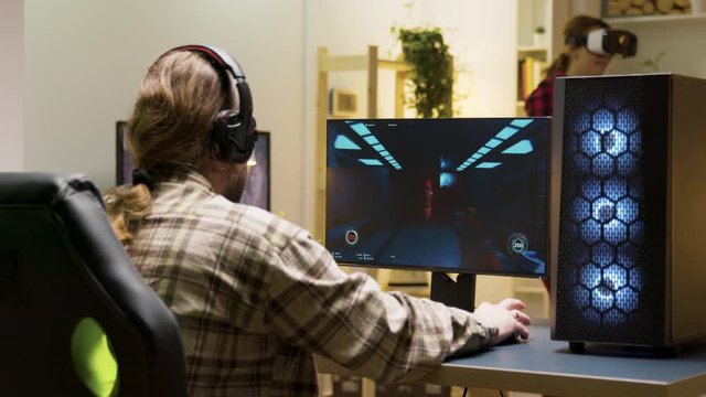 Man keeping his head on desk after losing at video games on computer