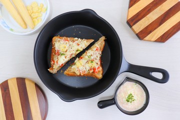 Chili Cheese toast, Open cheese sandwich or mini bread pizzas served with mayonnaise deep and garnished with chopped Basil leaves.