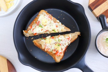 Chili Cheese toast, Open cheese sandwich or mini bread pizzas served with mayonnaise deep and garnished with chopped Basil leaves.