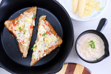 Chili Cheese toast, Open cheese sandwich or mini bread pizzas served with mayonnaise deep and garnished with chopped Basil leaves.