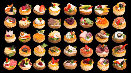 Assortment of tasty canapes on black background