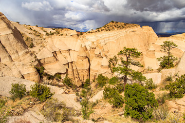 Fototapeta premium Landscape of rock formations against dark stormy sky in Kasha-Katuwe Tent Rocks National Monument in New Mexico, USA