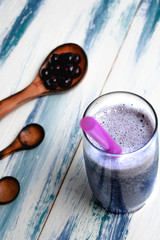 homemade blueberry smoothie on fresh white and blue wooden table
