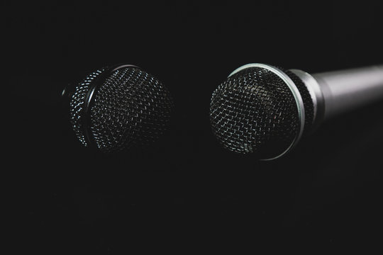 two microphones lie on a black background