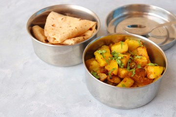 Stainless steel Lunch Box or Tiffin with Indian food menu Chapati or Roti, Garlic Dal Tadka, White...