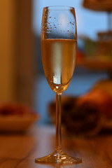 glass of sparkling champagne glowing in light new year party