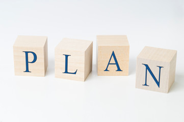 word plan on wooden cubes blue text on a white background, the concept of failure of the plan