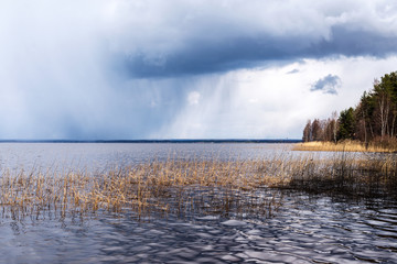 storm front over forest lake
