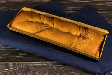 Fresh homemade baking bun on blue towel wooden background