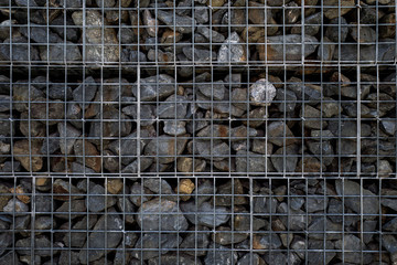 Rocks in steel cage wall background