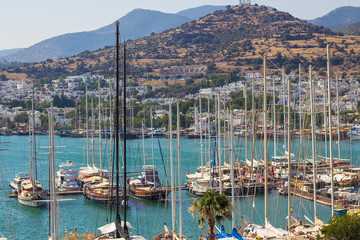 Fototapeta na wymiar Panoramic view from the walls of famous St Peter Castle in Bodrum, luxury white yachts, ships and sailing boats near the shores of blue Aegean sea, Mugla, Turkey. Travel concept. Turkish resort