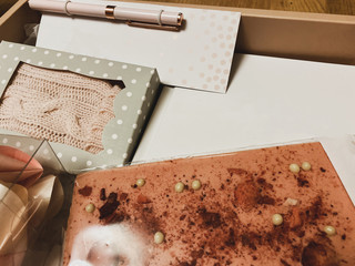 gift set in a pink box with a notebook, pen, chocolate bar and fortune cookies
