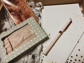 gift set in a pink box with a notebook, pen, chocolate bar and fortune cookies