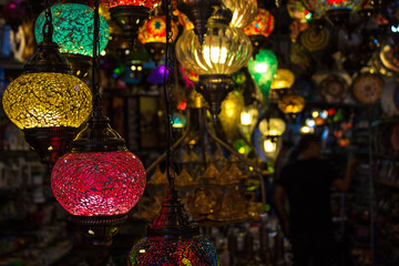 Colorful red, yellow and green turkish mosaic glass lamps for sale at the street market near Bodrum castle (also known as St Peter Castle), Mugla, Turkey. Closeup, Soft focus