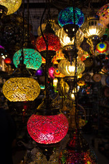 Colorful red, yellow and green turkish mosaic glass lamps for sale at the street market near Bodrum castle (also known as St Peter Castle), Mugla, Turkey. Closeup, Soft focus
