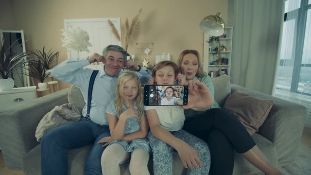 Grandparents and children are having fun while taking a selfie